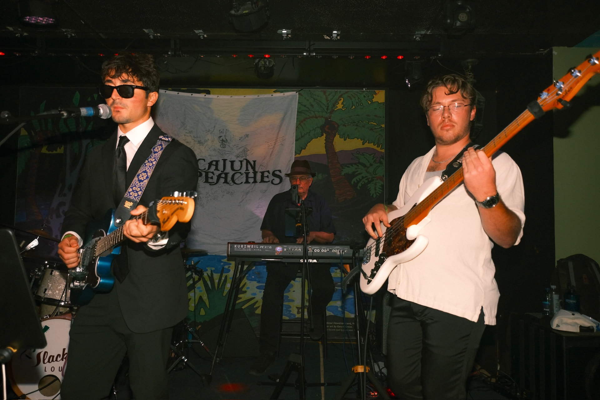 Adam playing guitar with his band live on stage